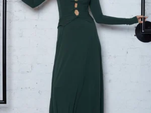 woman wearing a cut out green long dress with brown boots