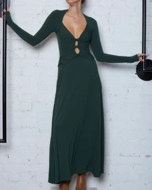 woman wearing a cut out green long dress with brown boots